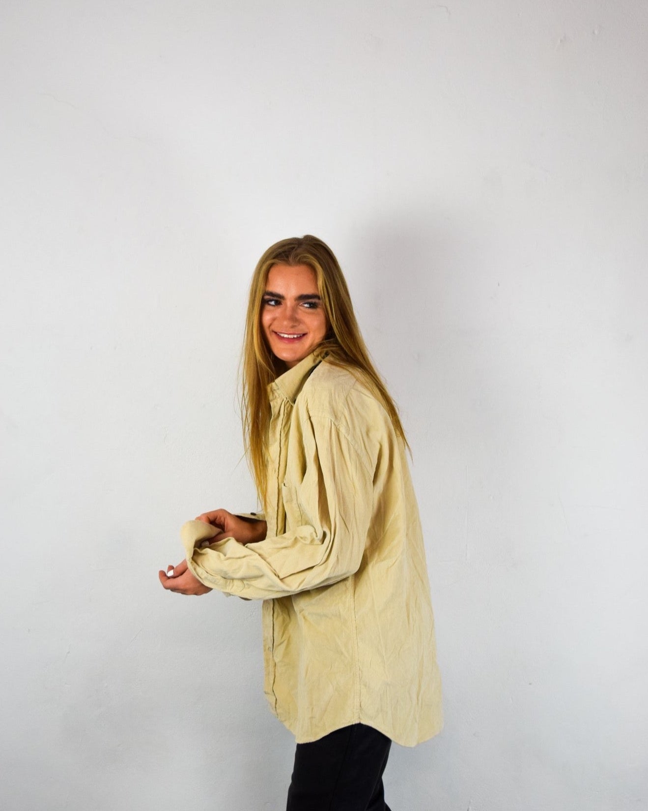 Girl smiling in corduroy shirt