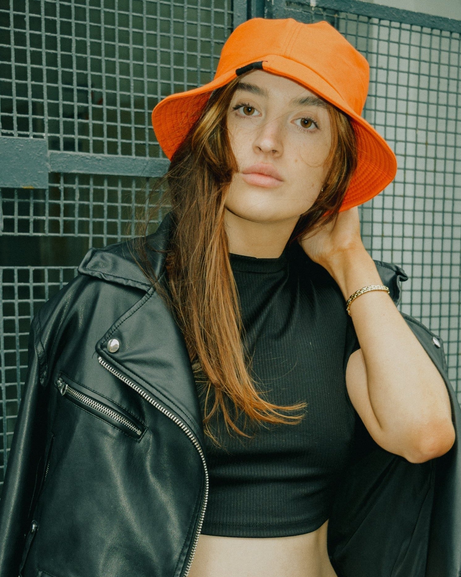 Female model wearing orange ML92 bucket hat